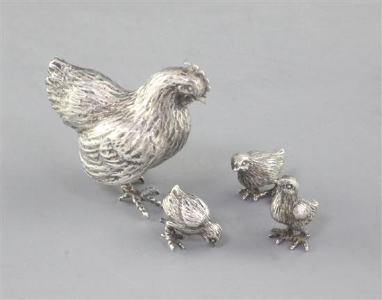 An Italian 800 standard white metal hen and three chicks.